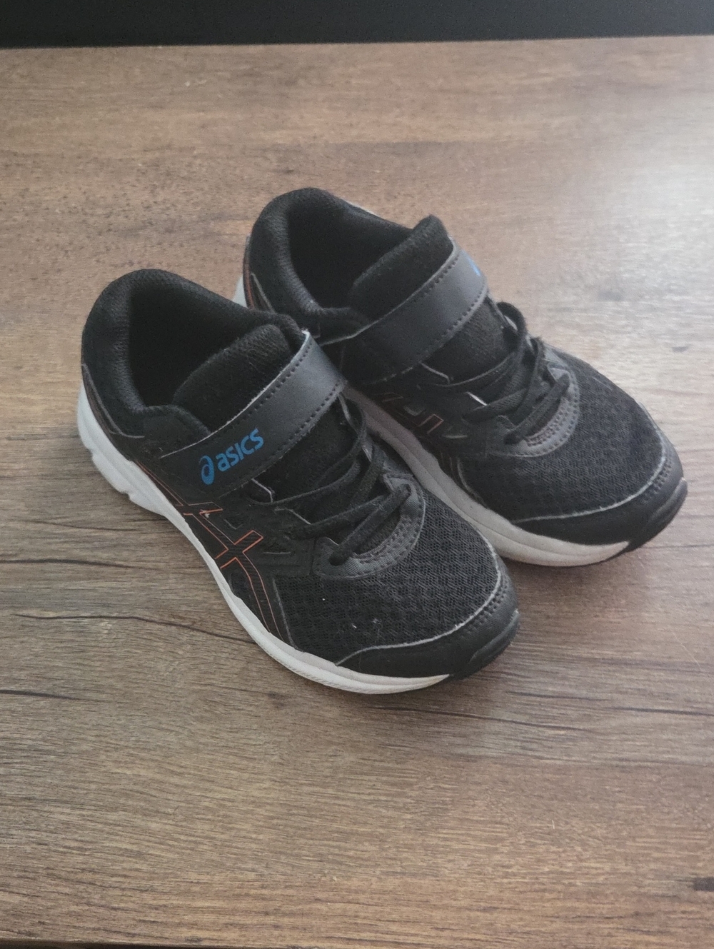 Asics Kids Black Sneakers with Blue Logo and Orange Accents